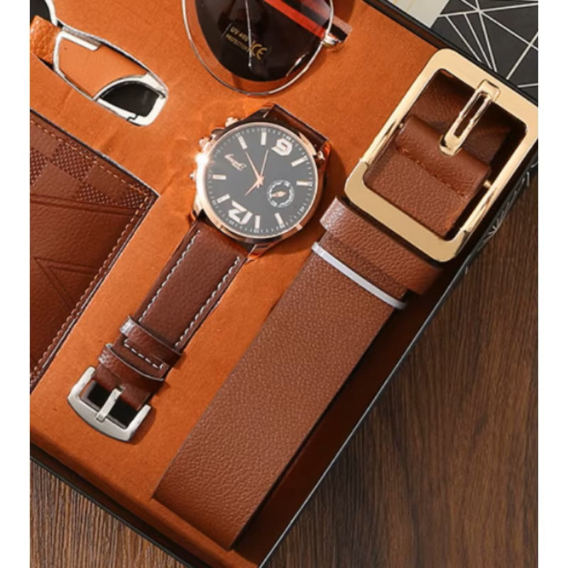 Watch with brown leather strap and gold accents in a display case.
